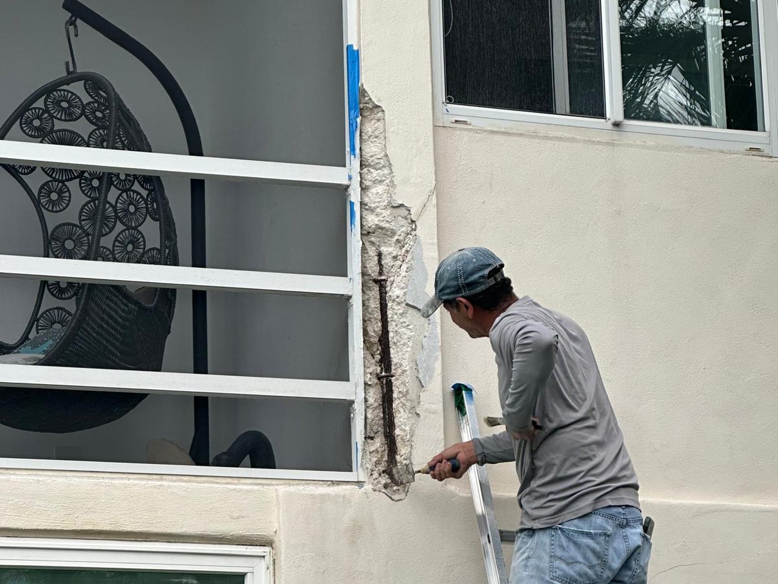 Painter finishing an occupied hallway with floors protected