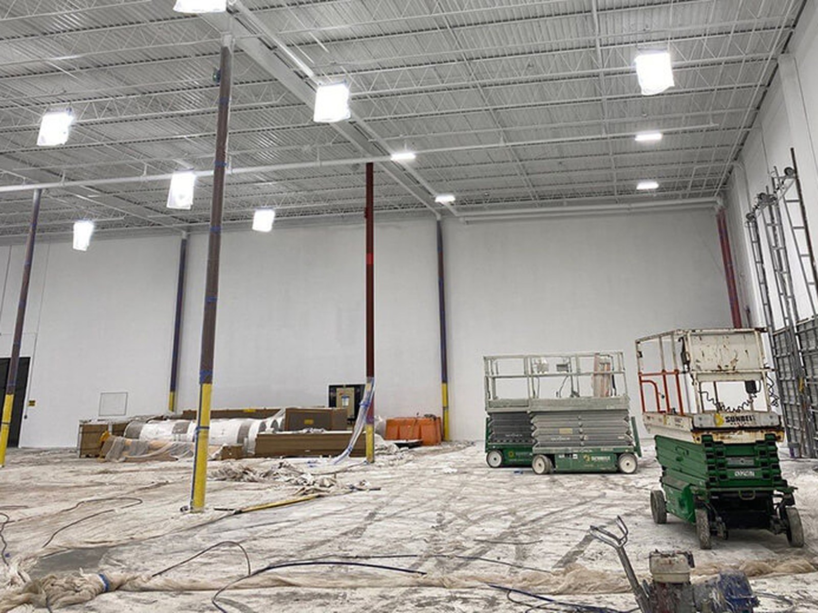 Commercial warehouse interior after painting, lifts still on the floor
